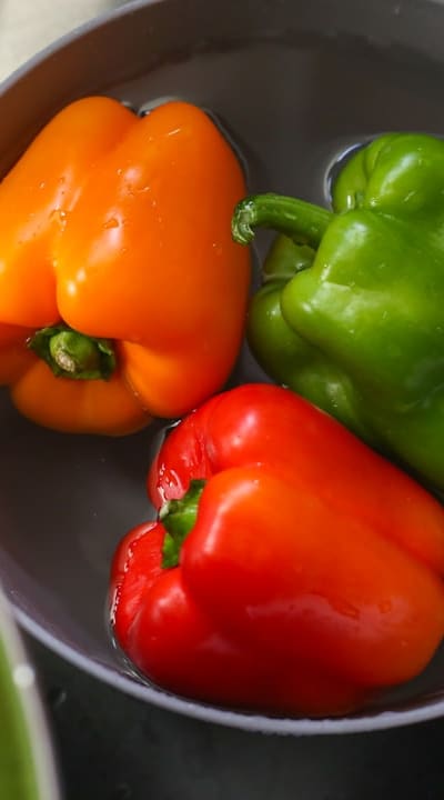 Pruning bell pepper plants to promote better growth.