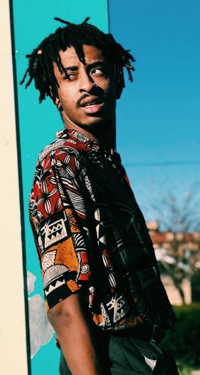 Pruning and training pole bean plants for optimal growth.