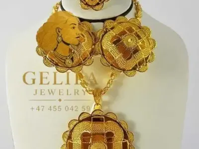 A beautifully handcrafted 21K gold necklace set featuring a statement pendant, matching earrings, and ring. Designed with intricate detailing and a radiant finish, this elegant collection is perfect for weddings, celebrations, and everyday luxury.
