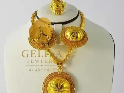 A beautifully handcrafted 21K gold necklace set featuring a statement pendant, matching earrings, and ring. Designed with intricate detailing and a radiant finish, this elegant collection is perfect for weddings, celebrations, and everyday luxury.