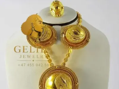 A beautifully handcrafted 21K gold necklace set featuring a statement pendant, matching earrings, and ring. Designed with intricate detailing and a radiant finish, this elegant collection is perfect for weddings, celebrations, and everyday luxury.
