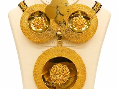 A beautifully handcrafted 21K gold necklace set featuring a statement pendant, matching earrings, and ring. Designed with intricate detailing and a radiant finish, this elegant collection is perfect for weddings, celebrations, and everyday luxury.