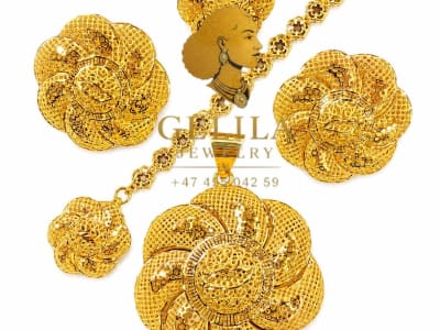 A beautifully handcrafted 21K gold necklace set featuring a statement pendant, matching earrings, and ring. Designed with intricate detailing and a radiant finish, this elegant collection is perfect for weddings, celebrations, and everyday luxury.