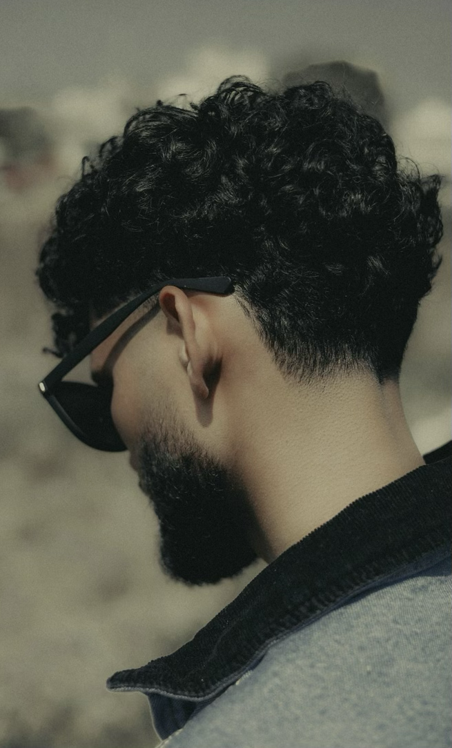 Men's textured curl with fade, back view
