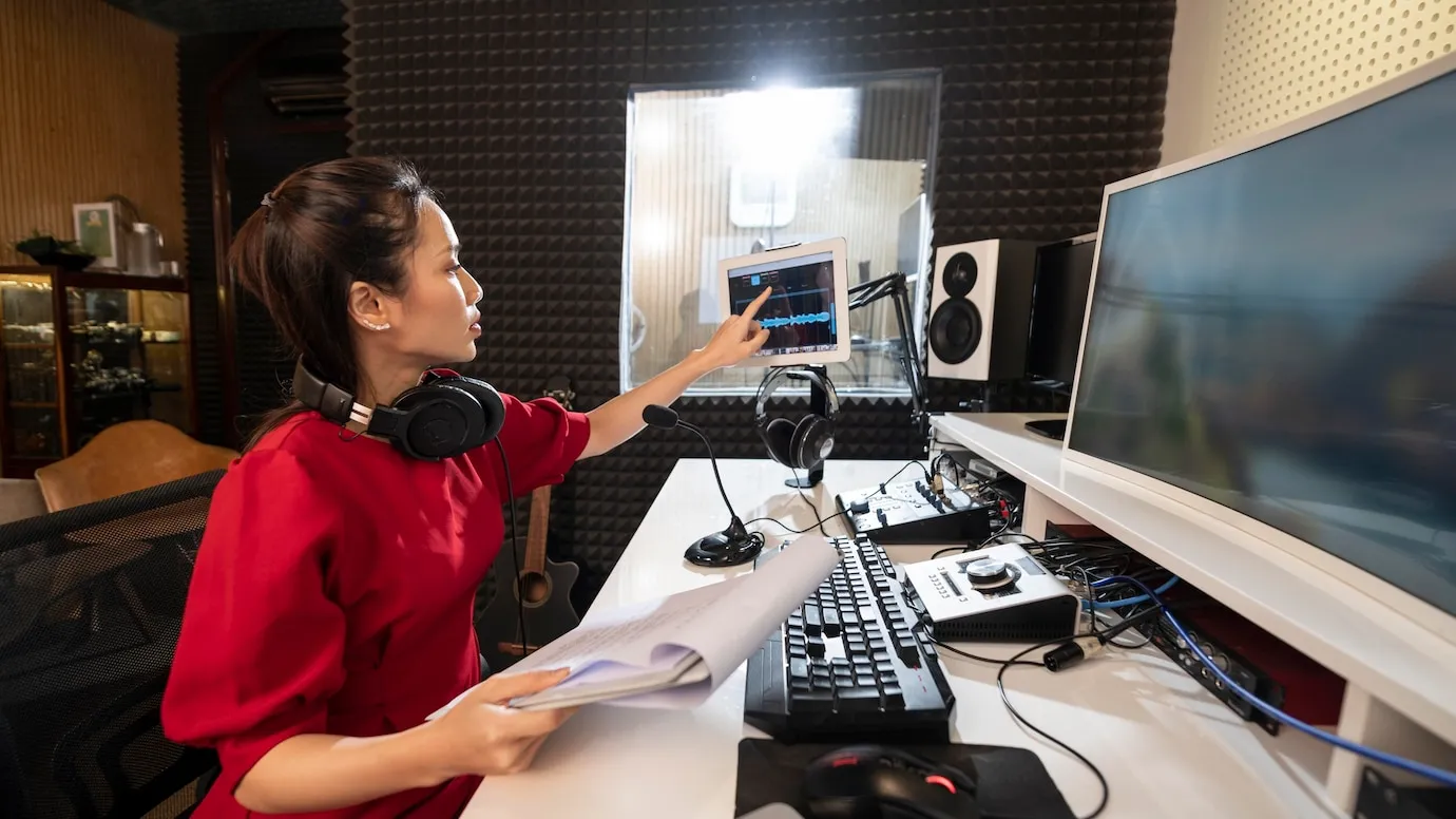 Person reviewing audio recordings for noise analysis.