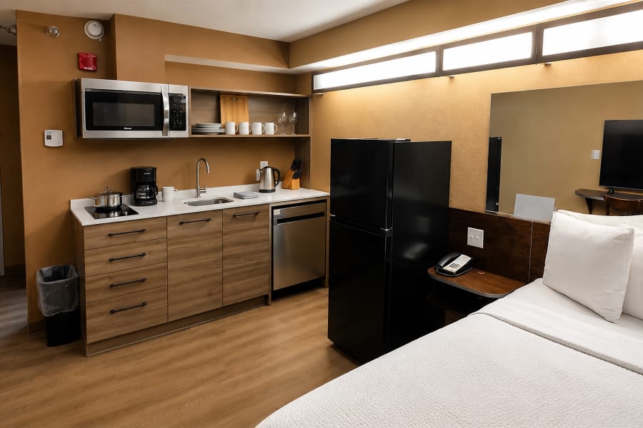 Full kitchenette — microwave shelf, fridge and complete appliance setup