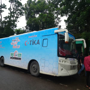 Blue healthcare vehicle with "TiKa" branding, likely promoting healthcare services.