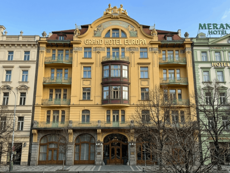 Ornate gold Art Nouveau facade of Grand Hotel Europa on Wenceslas Square, a landmark of Prague architecture.