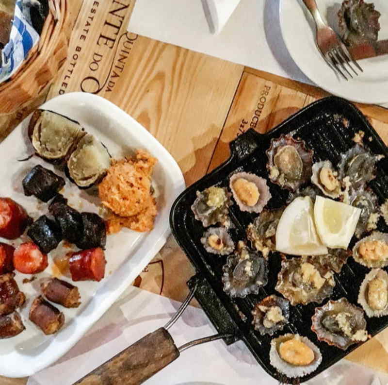 A table set with various plates of food, showcasing a colorful assortment of dishes ready for serving.