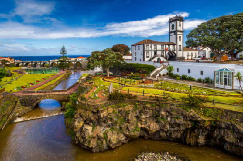 Scenic view of the beautiful island of São das Cruz as, Portugal, showcasing lush greenery and coastal cliffs.