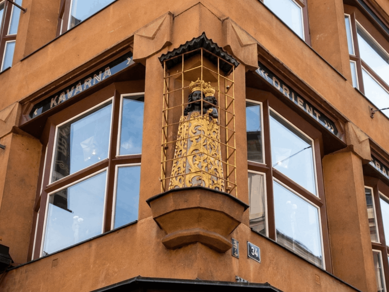 Gilded Black Madonna statue on the corner of the House of the Black Madonna, an iconic Cubist building in Prague.