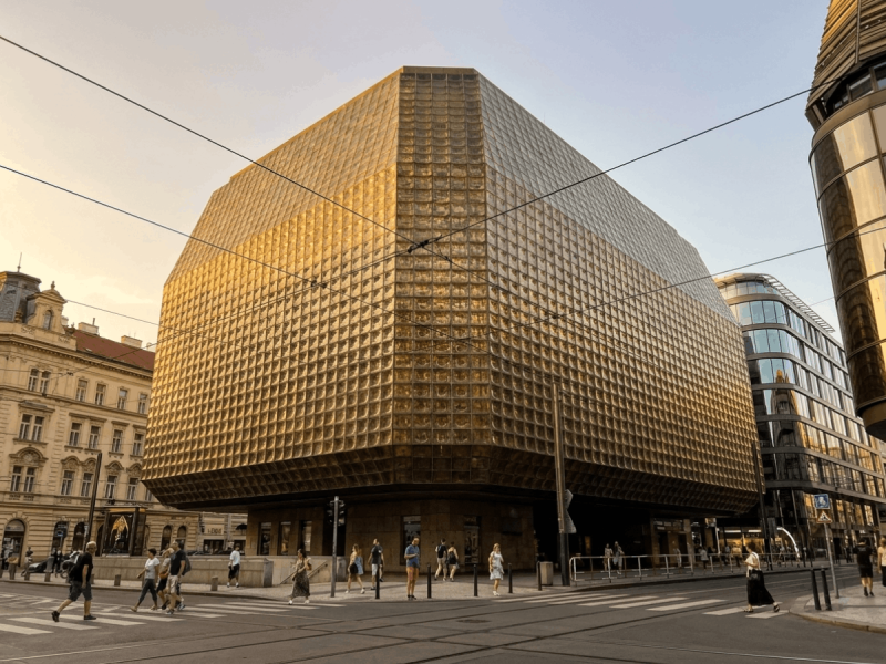 Faceted golden glass block facade of Nová Scéna (New Stage), a striking example of modern Prague architecture.