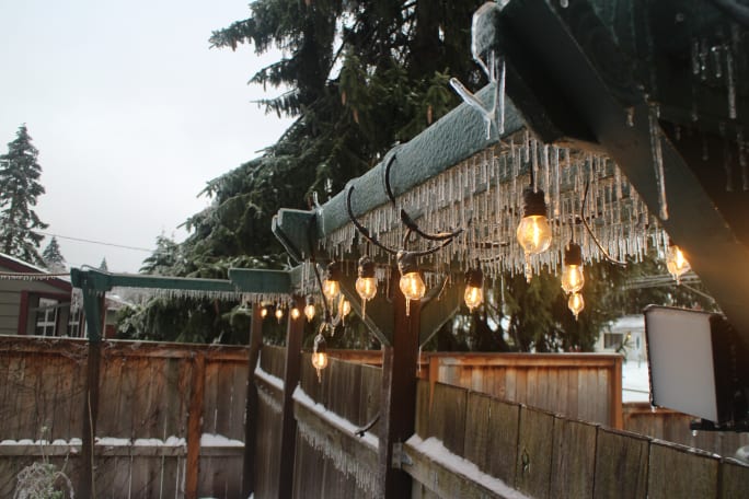 Icicles and lights hanging off a trellis