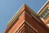 The corner of a building, shot as though the camera is looking up at the prow of a ship