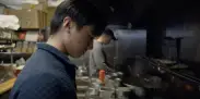two men work in a chinese food resaurant
