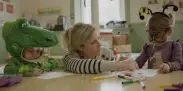 woman workign with two kids in costume