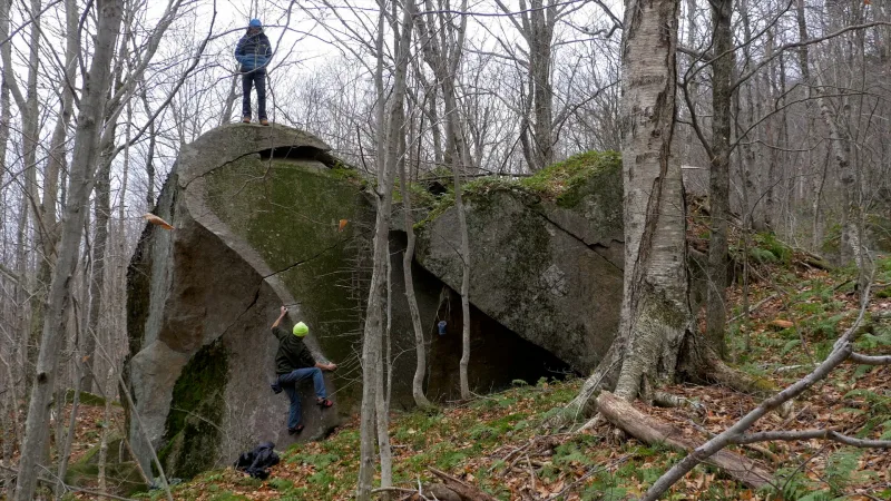 Aron standing on top of large boulder