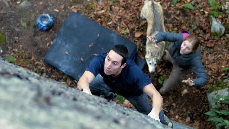 Melissa spotting Aron on boulder