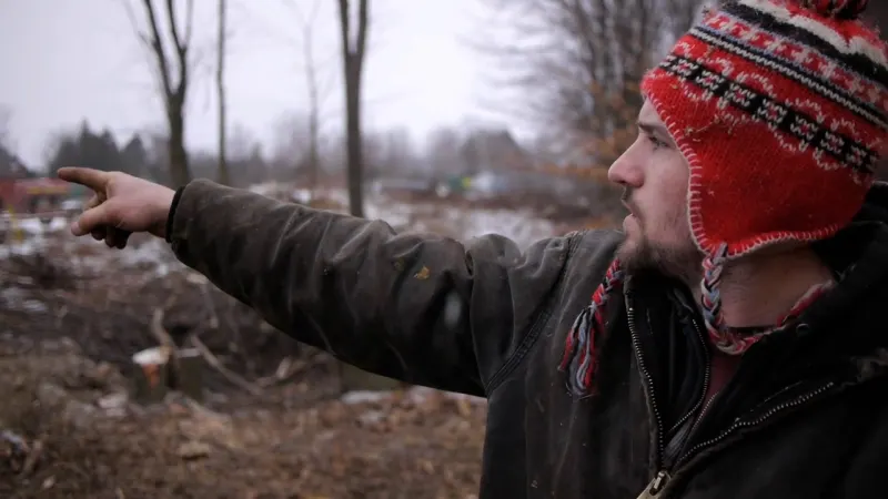 dustin in snow pointing