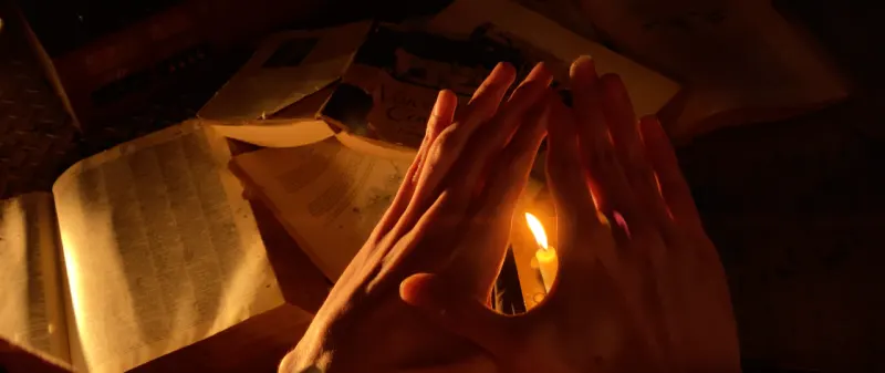 hands reveal a candle