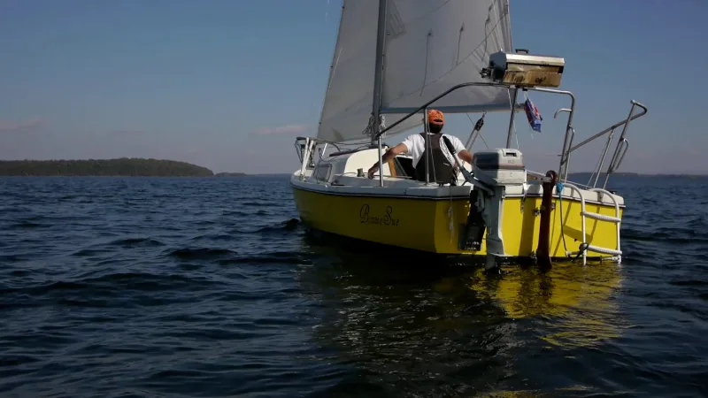 wide shot of boat sailing on lake champlain