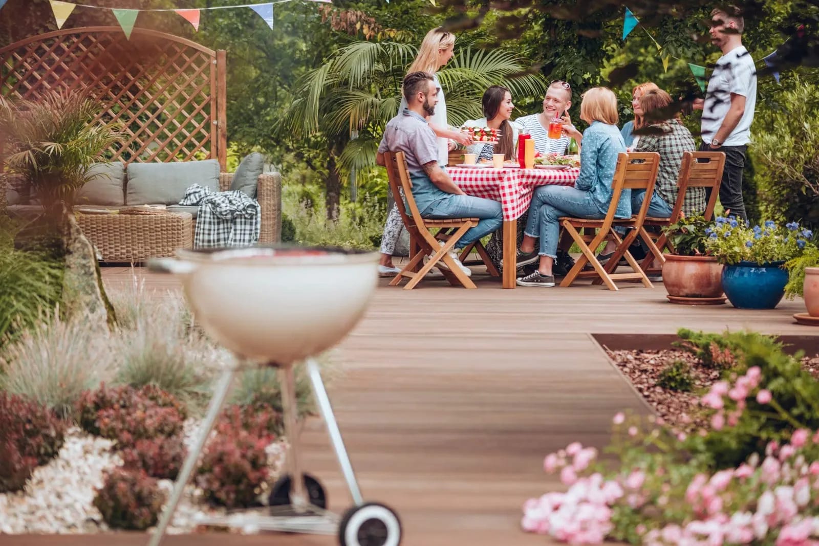 Grande terrasse en bois clair prolongeant le salon d'une maison contemporaine, idéale pour la détente.
