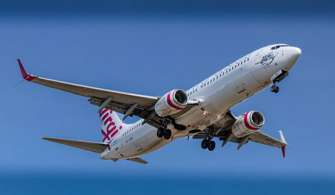 Virgin Australia aircraft in flight — ME CABS fixed-fare Melbourne Airport transfers from Rowville and across Knox