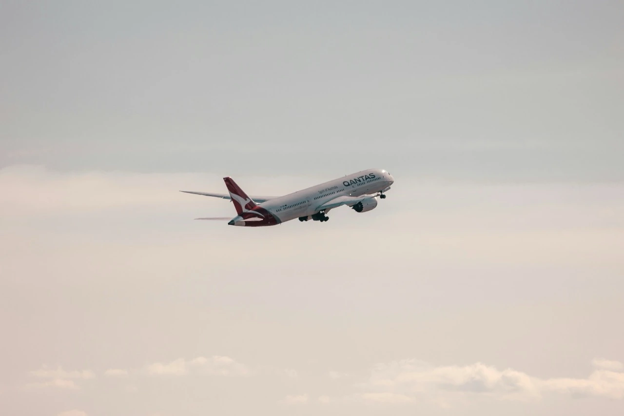 An aircraft climbing against a sunset sky — the Southbank run to Melbourne Airport