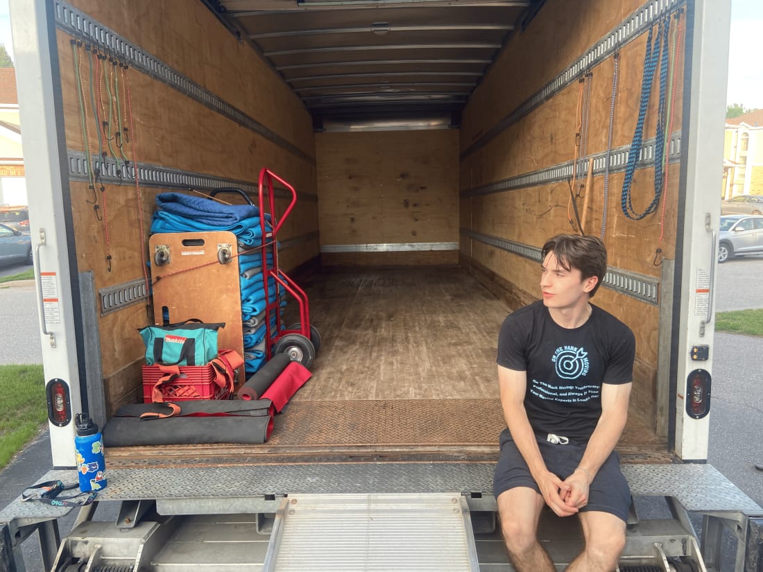 On The Mark Moving team member sitting beside a prepared moving truck in London Ontario