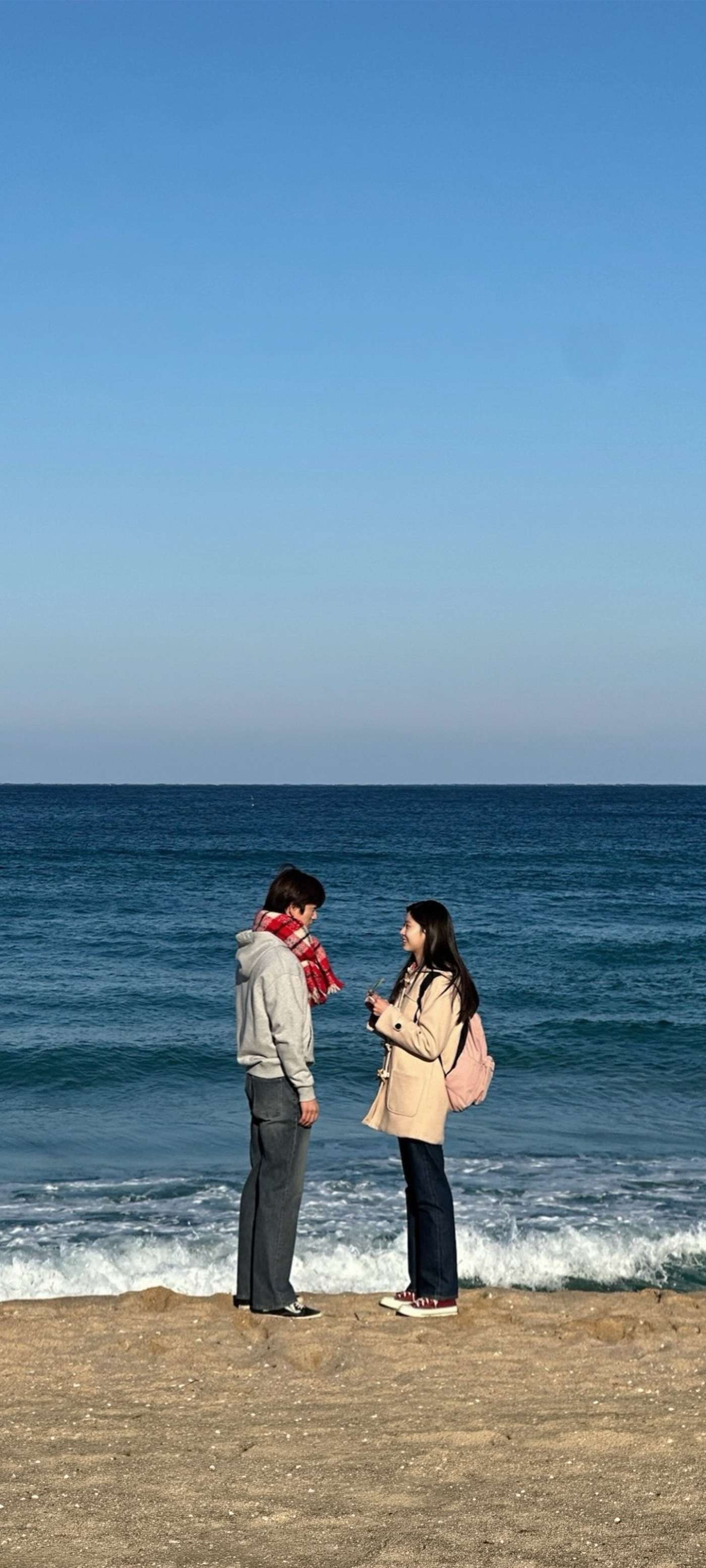 Winter Beach Couple by the Sea — phone wallpaper preview