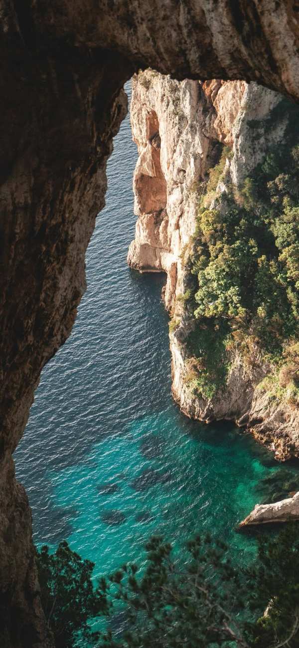 Coastal Archway Over Turquoise Sea — phone wallpaper