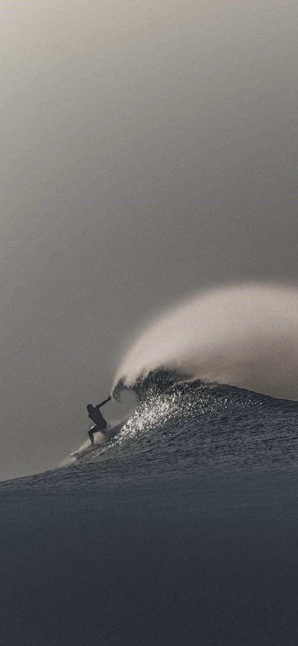 Silhouetted Surfer on Crashing Wave — phone wallpaper