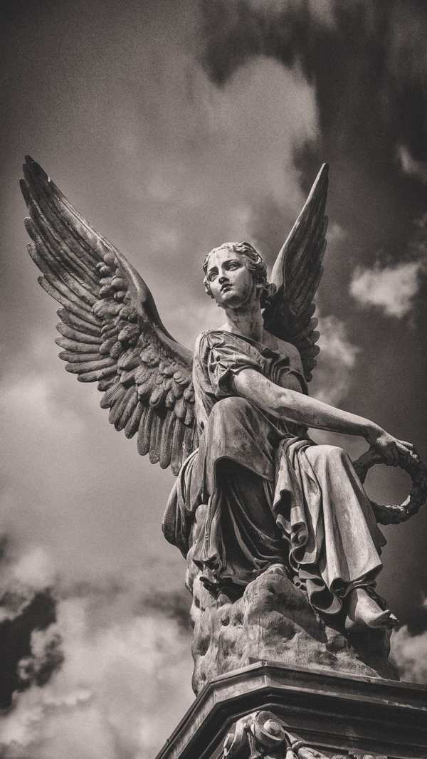 Serene Angel Statue Cloudy Sky — phone wallpaper