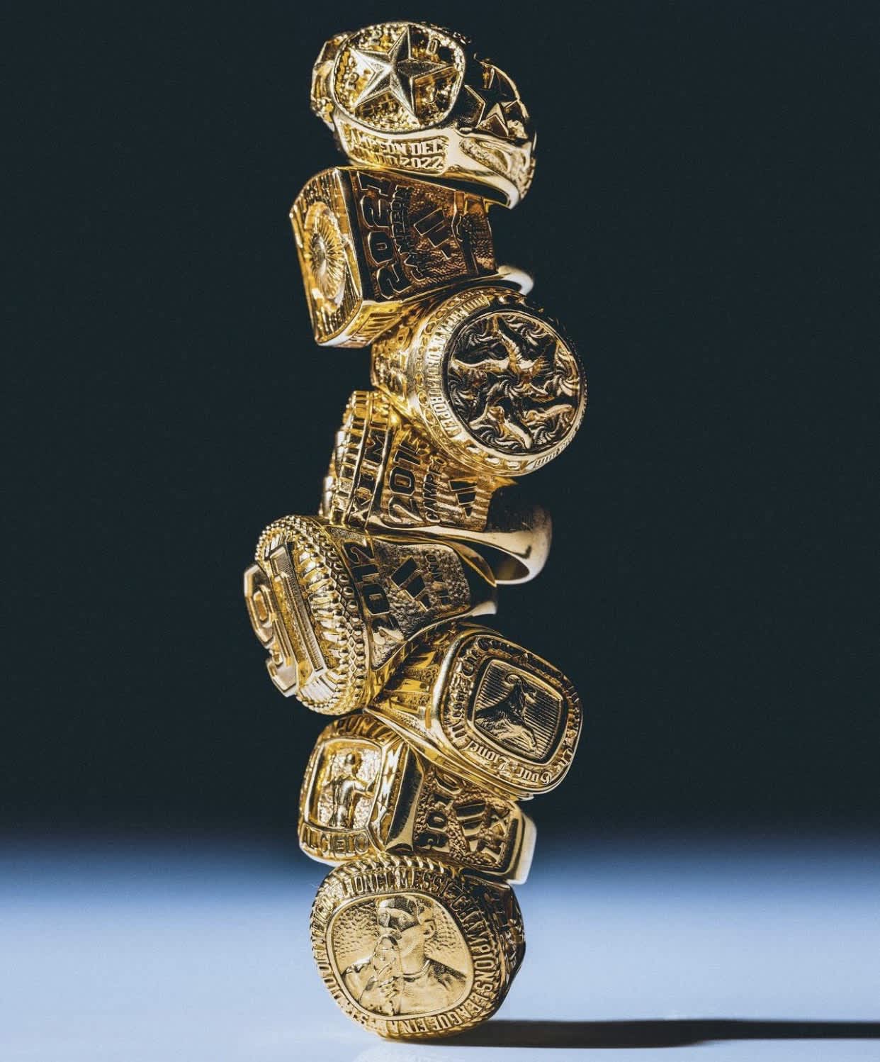 Golden Championship Rings Stack — phone wallpaper preview