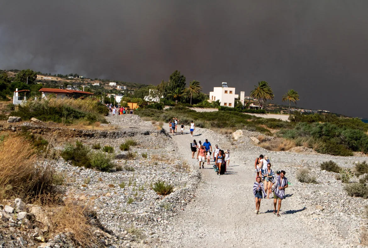 Tourists are being evacuated as wildfire burns near Lindos on the island of Rhodes.