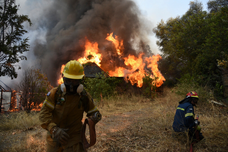 Firefighters operate during a wildfire, 2021.