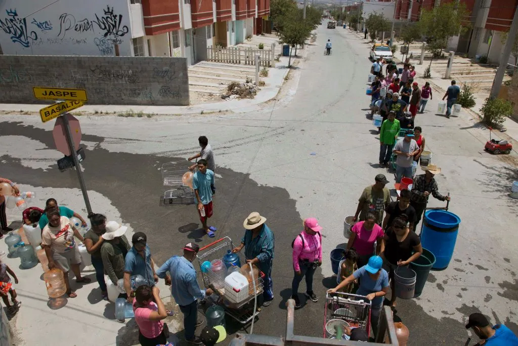 Residents queue to collect clean water