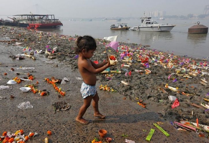 A child on the banks of the polluted Cooum River
