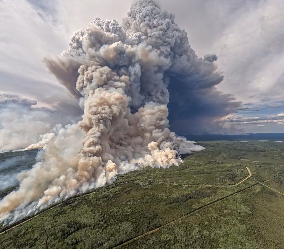 Smoke billows upwards from a planned ignition by firefighters tackling the Donnie Creek Complex wildfire south of Fort Nelson, British Columbia, Canada, June 3, 2023.