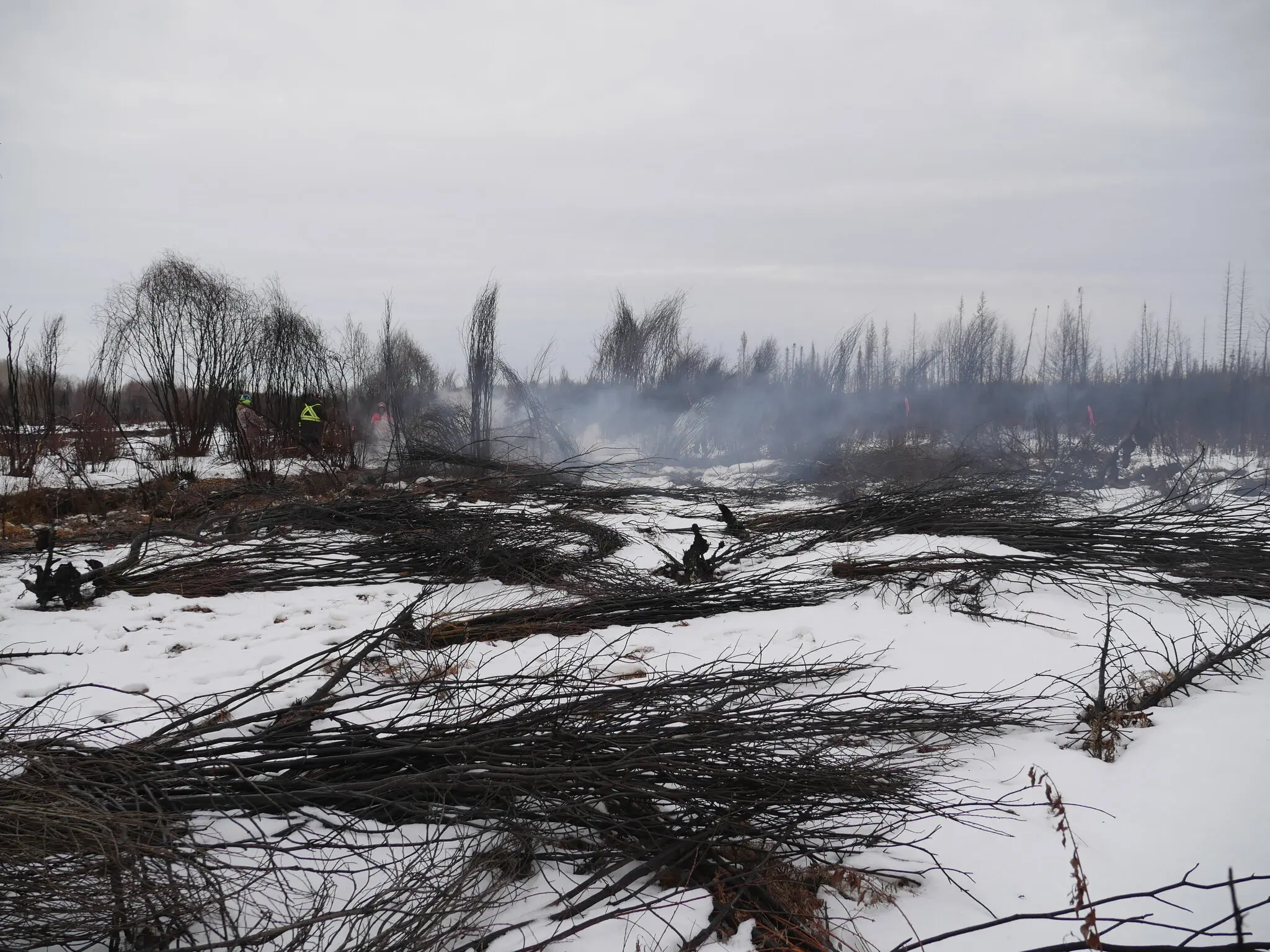 This photo released by a Canadian fire department shows crews battling a fire last month that persisted despite the cold and snow in Alberta, Canada.