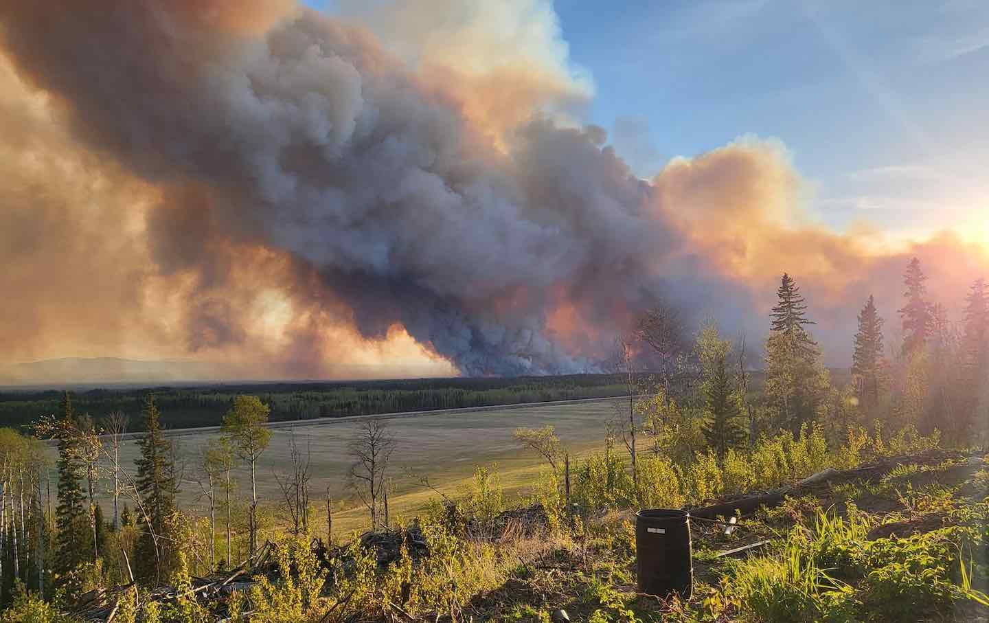 Smoke rises after fire erupts in Western Canada on May 14, prompting thousands to flee their homes.