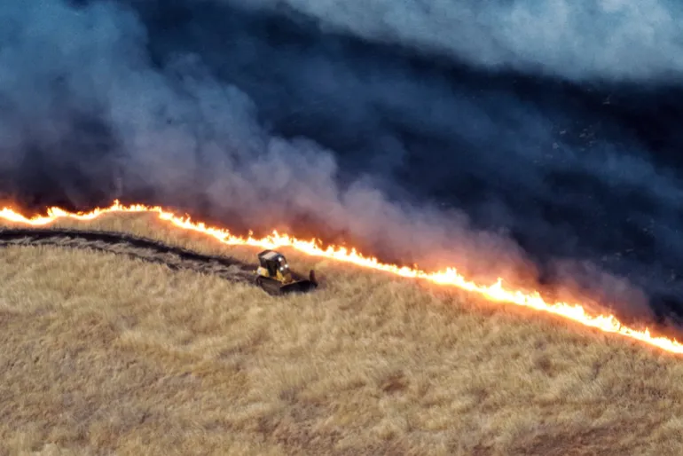 A bulldozer works against the Corral Fire on Sunday, June 2, 2024, near Tracy, California, the US