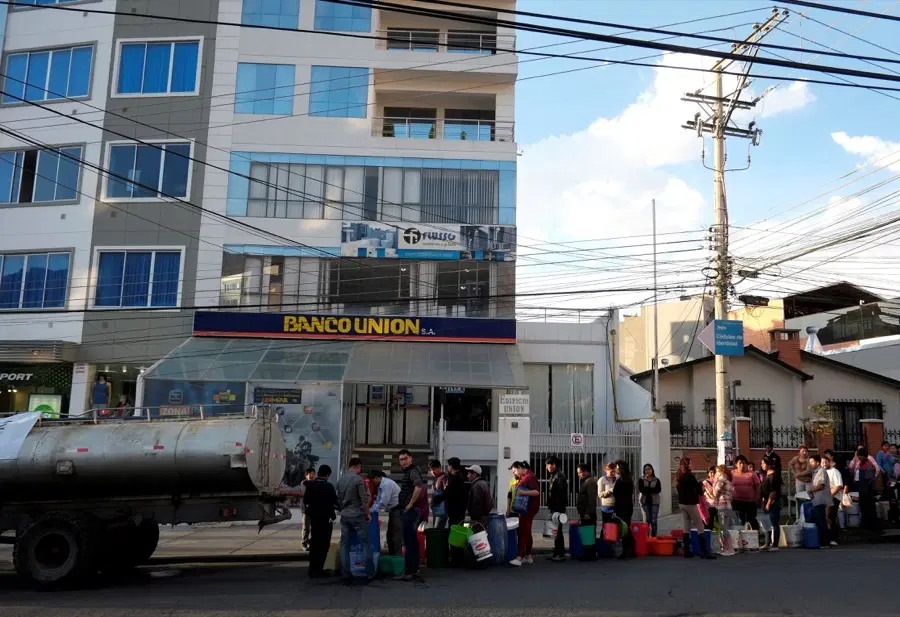 Bolivians stand in line to collect water from a truck in La Paz.