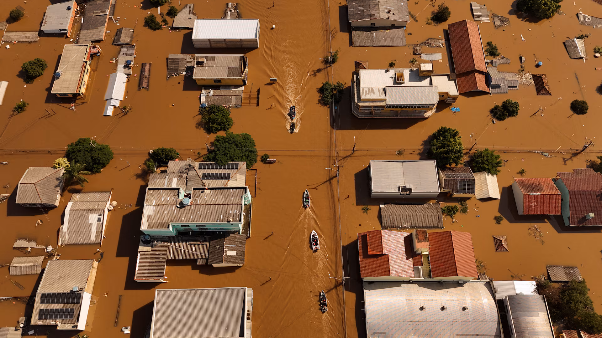 A drone view shows boats with volunteers searching for people isolated at houses at the flooded neighborhood of Mathias Velho in Canoas.