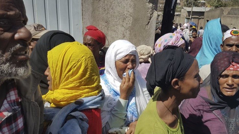 Local residents display their grief as bodies are recovered from the massive landslide