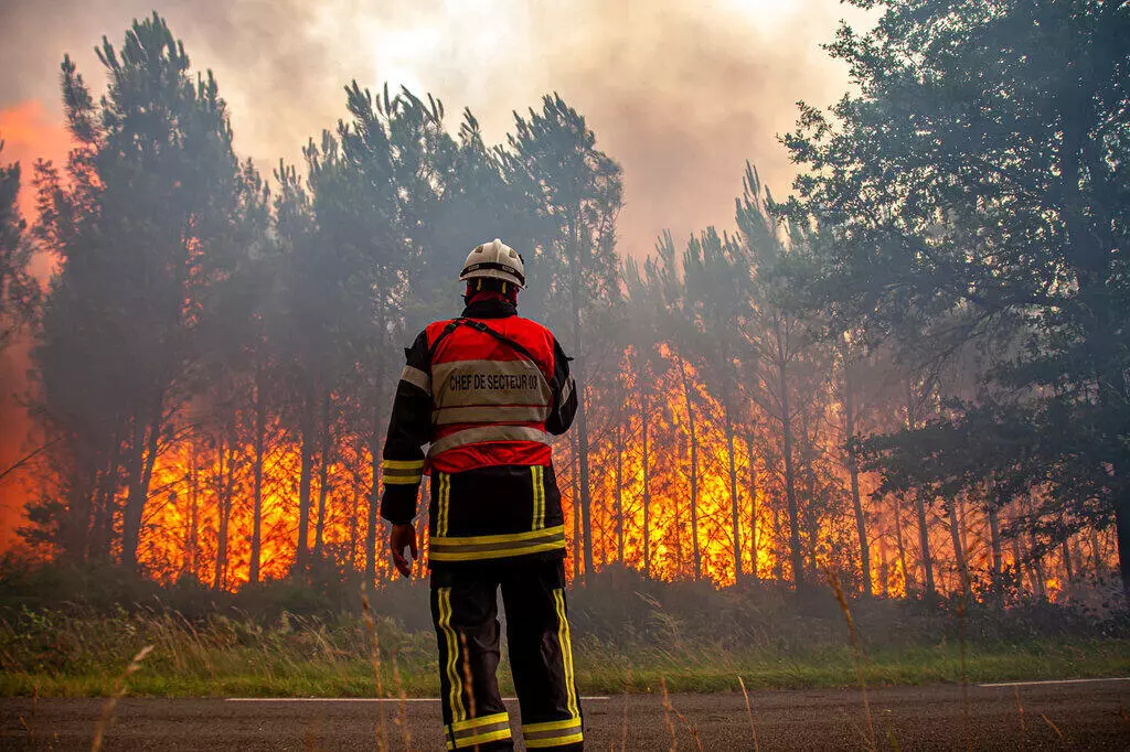 A firefighter faces raging wildfire near Landiras, southwestern France