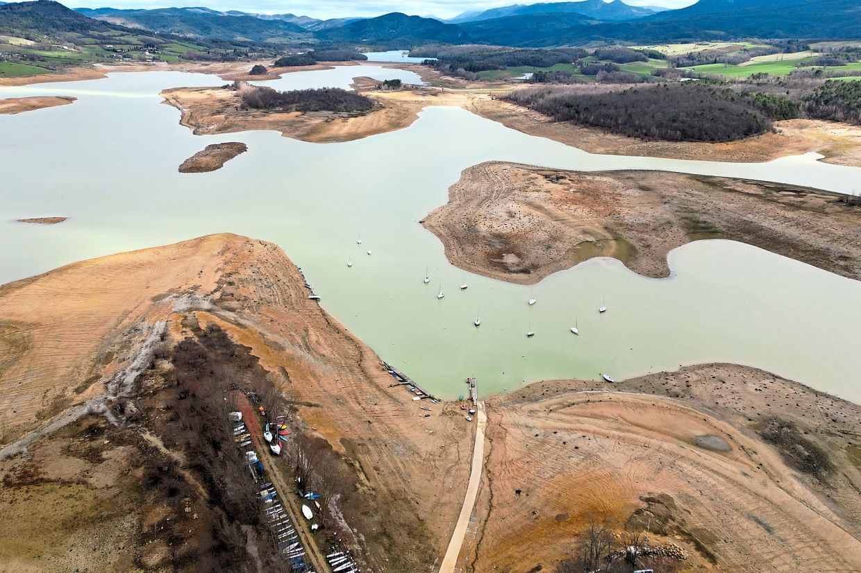 view of the partially dry Lake Montbel at the foot of the Pyrenees Mountains in France