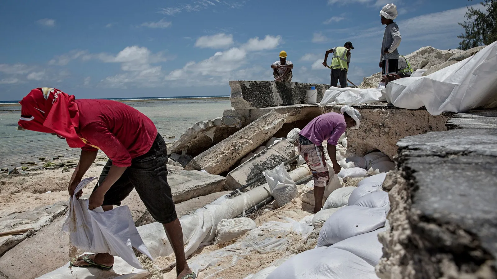 Locals regularly have to repair roads damaged by flooding on the islands in the Republic of Kiribati