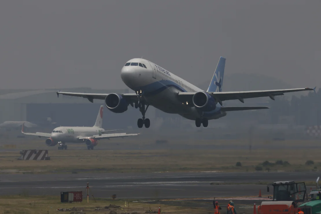 Jetliners take off from the Benito Juarez International Airport as smoke and pollution hangs Mexico City, Thursday, May 16, 2019.