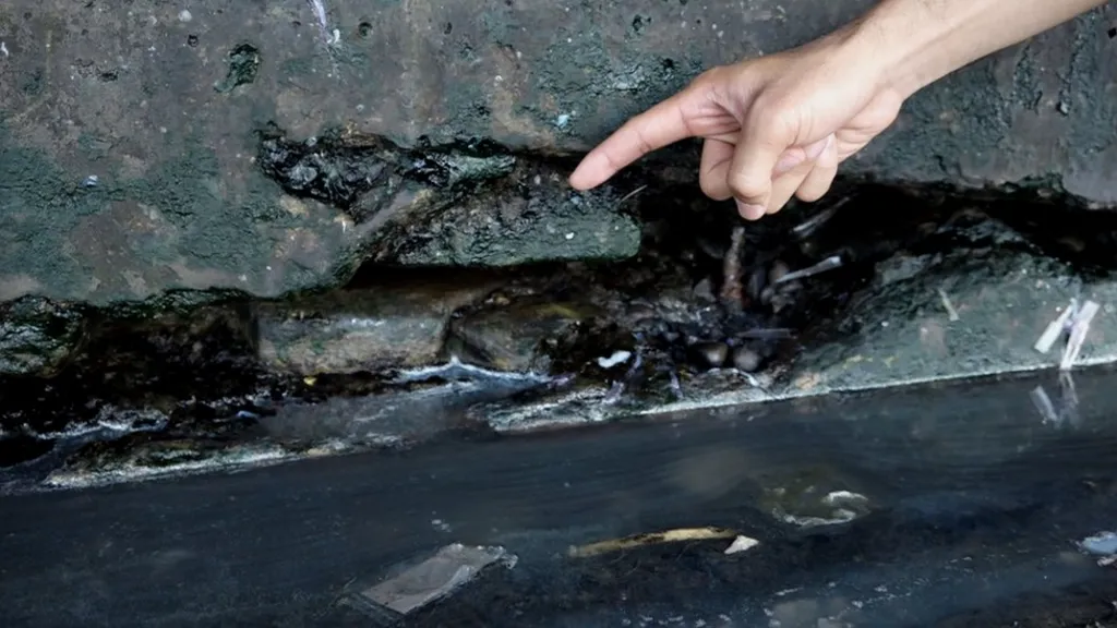 A large crack in the foundation of a fish market that has seen severe land subsidence